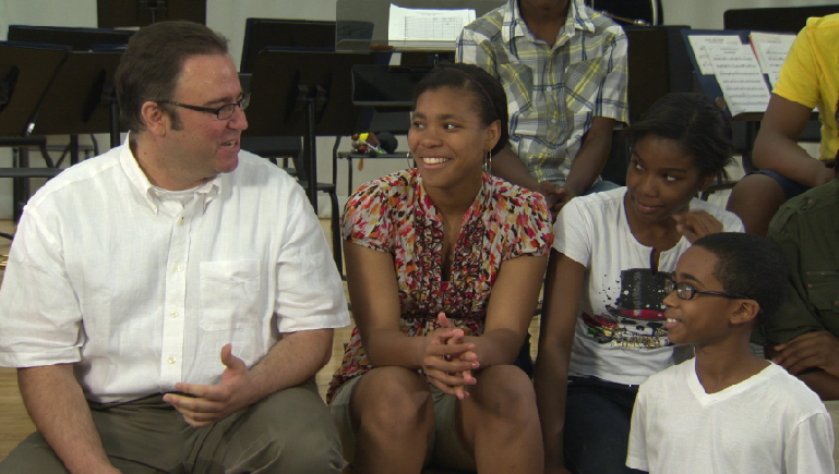 Christopher Theofanidis chatting with students at Betsy Ross Arts Magnet Middle School Band in New Haven, CT (2011).
